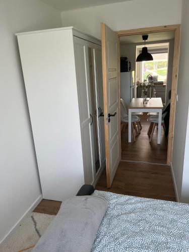 a room with a door leading to a dining room at Bazsarózsa Kuckó in Pécsvárad
