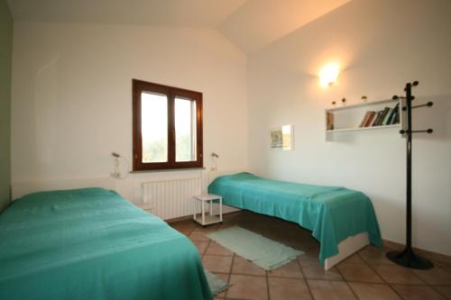 En eller flere senge i et værelse på Due casette in campagna non lontane dal mare