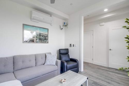 a living room with a couch and a chair at Park Blvd 302 - Newly Built - Spa - Central in San Diego