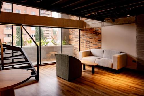 a living room with a couch and a table at Uukam by Bernalo Hotels in Medellín