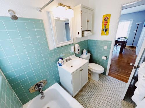 a bathroom with a white sink and a toilet at Great Escape Apartments By Lowkl in Fort Lauderdale