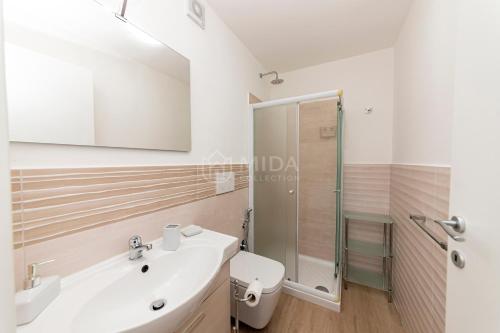 a bathroom with a shower and a white sink at LORY'S HOUSE in Porto Cesareo