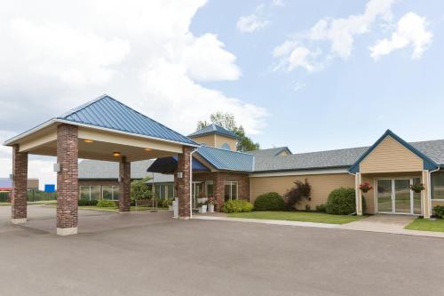 a large house with a garage at Days Inn & Suites by Wyndham Moncton in Moncton