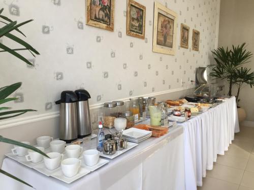a buffet table with food and drinks on it at Silver Lis Hotel in Acailandia