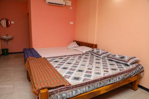 a bedroom with a bed in a room at Annu Mane Homestay in Gokarna
