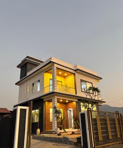 a large house with a fence in front of it at ll EMPYREAN STAYS ll G0DFATHER VILLA ll MASTERPIECE ll 4BHK ll AC ll LARGEST POOL ll in Lonavala