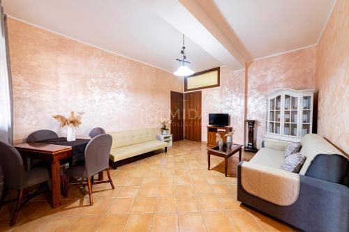 a living room with a couch and a table at Maridea Flat in Porto Cesareo