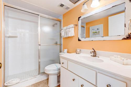 a bathroom with a shower and a toilet and a sink at Van Lee 1003 - Oceanview Beach Condo in Ormond Beach