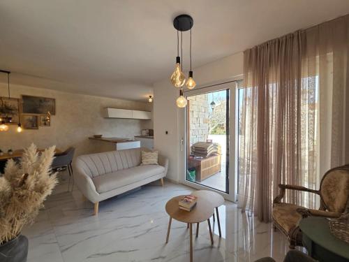 a living room with a couch and a table at Guest house Noemi in Marčana