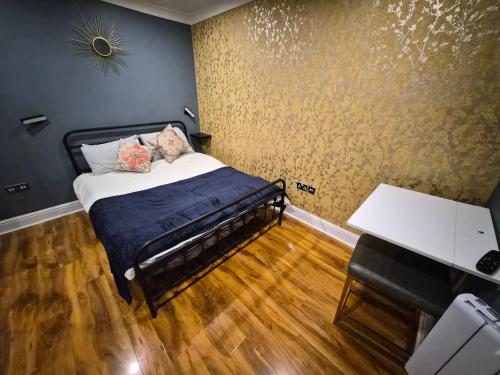 a small bedroom with a bed and a desk at Dodi Aparts London, near Stratford close to tube station in London