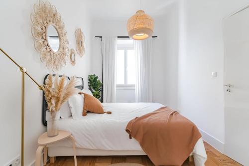 a bedroom with a bed with a mirror on the wall at Charming Lisbon 2BR Apartment with Balcony in Lisbon