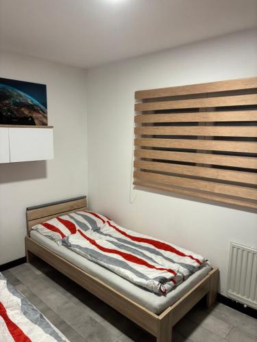 a bedroom with a bed with a wooden headboard at Bedřichov Jaroš in Bedřichov