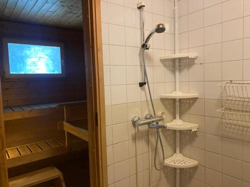 a shower in a bathroom with a shower head at Loft house Karihaara in Kemi