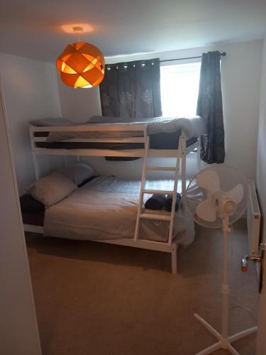 a bedroom with a bunk bed and a light at Heronsgate GH018 in Kent