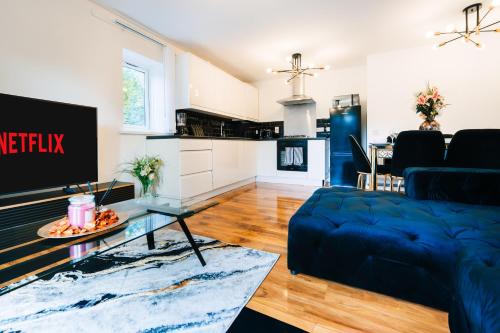 a living room with a couch and a table at LUX 2BDR Flat in Woolwich I 2 Stops to Canary Wharf & Excel I Free Parking in Woolwich