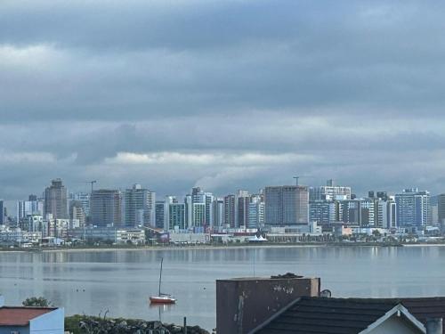 a large city with a large body of water and buildings at Casa Maria Mar in São José