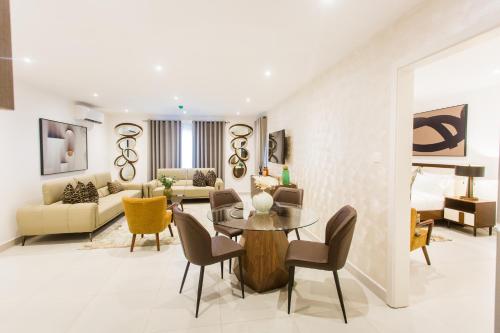 a living room with a table and chairs at Accra Luxury Apartments at The Bantree in Accra