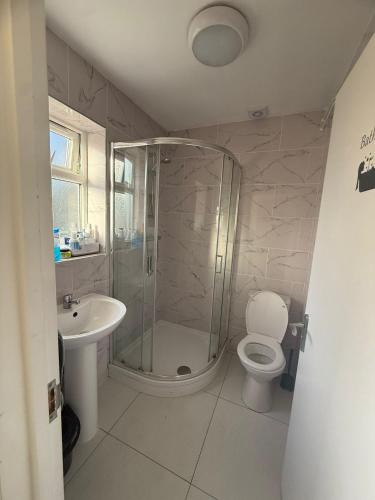 a bathroom with a shower and a toilet and a sink at Fina's House - Moments from Tottenham Hotspur Stadium in London