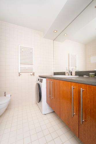 a bathroom with a sink and a washing machine at Large One Bedroom Flat - Mountain Bliss in Borovets