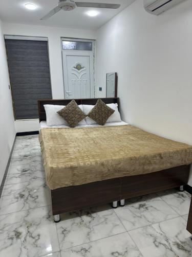 a bedroom with a large bed in a room at Jadriya Serviced Residences in Baghdad
