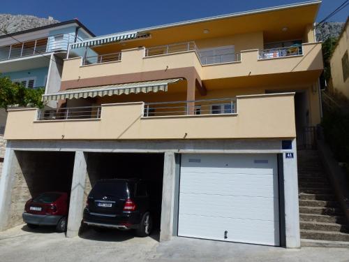 a car parked in front of a building with a garage at Seaview Apartment Tony with Grand Terrace in Omiš