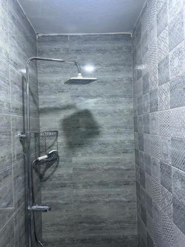 a bathroom with a shower with a glass door at Jadriya Serviced Residences in Baghdad
