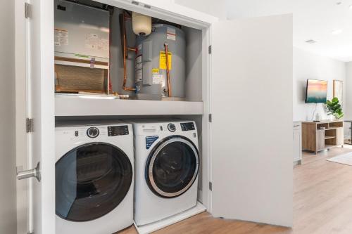 a laundry room with a washer and dryer at Lux Studio Apt - Rooftop - 5 mins to The Fillmore in Philadelphia