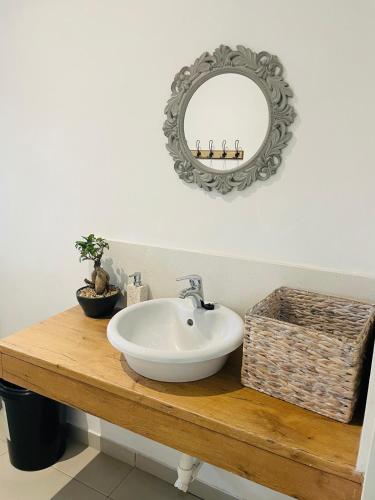a bathroom with a sink and a mirror at Place on Oak 3 in Bulawayo