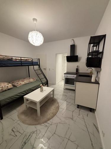 a room with a bed and a table in a room at Cologne 20 min Tram 1 min, Top City Apartment in Niederdorla