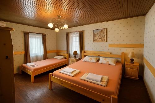 a bedroom with two beds and a wooden ceiling at Complex Ristanite in Elena