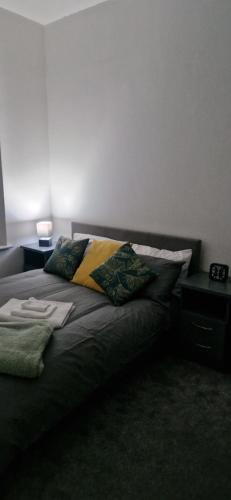 a bed with two pillows on it in a room at Sarah's Woodland Golf Stays in Waterloo