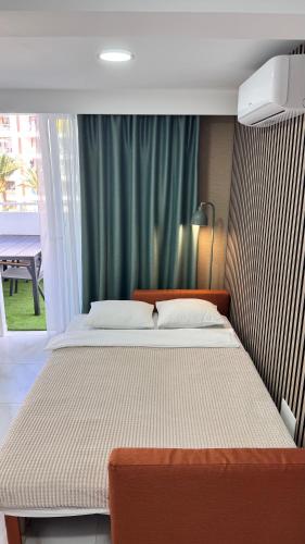 a bedroom with a large bed in front of a window at Las Americas 200A apartment in Costa de Adeje