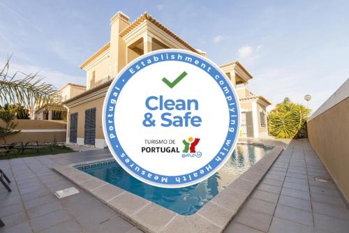 a sign for a clean and safe sign in front of a house at D09 - Porto de Mos Luxury Villa in Lagos