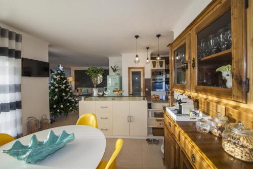 a kitchen with a table and a christmas tree at D09 - Porto de Mos Luxury Villa in Lagos