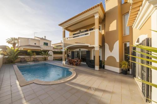 a villa with a swimming pool and a house at D09 - Porto de Mos Luxury Villa in Lagos