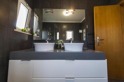 a bathroom with two sinks and a large mirror at D09 - Porto de Mos Luxury Villa in Lagos