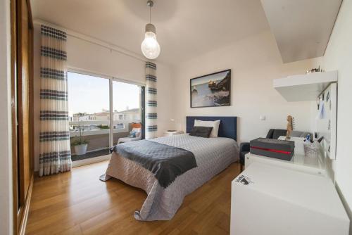 a bedroom with a bed and a large window at D09 - Porto de Mos Luxury Villa in Lagos