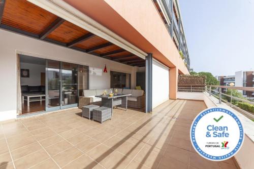 a patio with a table and chairs on a building at C16 - Landeiro MarinaPark Apartment in Lagos