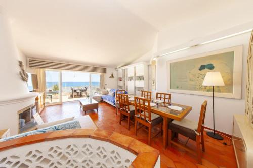 a living room with a table and a dining room at C22 - Beco do Poço Beach Townhouse in Praia da Luz in Luz
