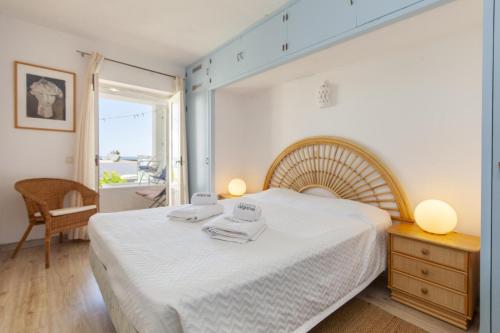 a bedroom with a large white bed and a window at C22 - Beco do Poço Beach Townhouse in Praia da Luz in Luz