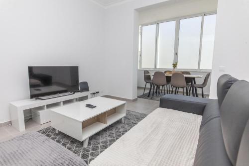 a living room with a couch and a tv and a table at C09 - Portimão 3 Bed Holiday Apartment in Portimão