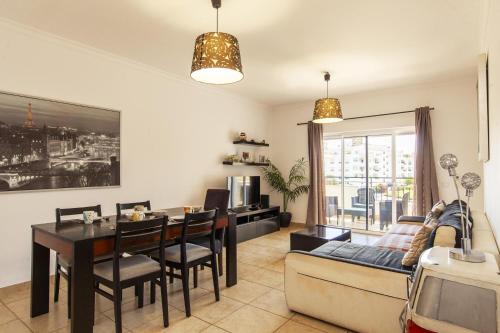 a living room with a table and a couch at C02 - Luxury 3 Bed With Pool View in Lagos