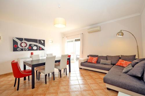 a living room with a table and a couch at C03 - Galé Holiday Apartment in Lagos in Lagos