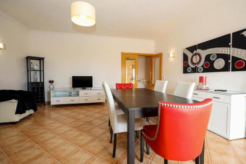a living room with a dining room table and chairs at C03 - Galé Holiday Apartment in Lagos in Lagos
