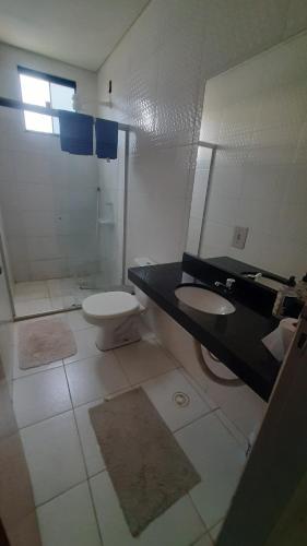a bathroom with a toilet and a sink at Edifício Nilson Pimentel in Barreiras