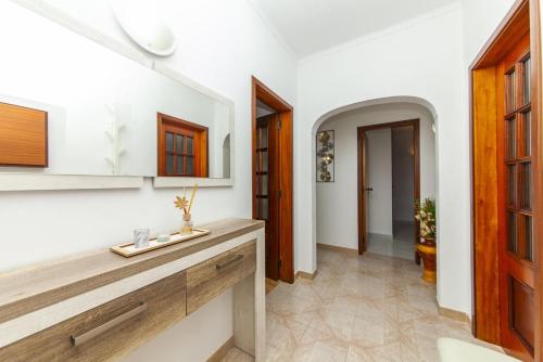 a kitchen with white walls and wooden cabinets at D02 - Carrob Street House in Lagos