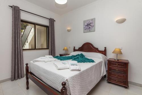 a bedroom with a bed with two towels on it at D02 - Carrob Street House in Lagos