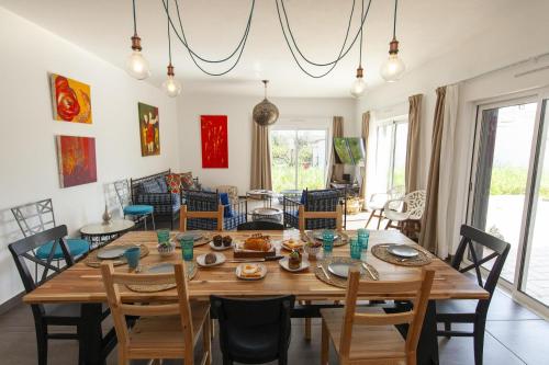 a dining room with a large wooden table and chairs at D13 - Eiras Velhas Holiday House in Almádena in Almádena