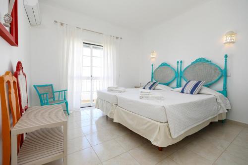 a bedroom with a large bed with blue accents at C13 - Ameijeira Holiday Apartment in Lagos in Lagos
