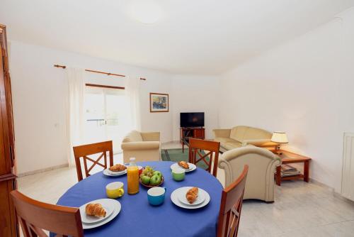 a living room with a blue table with food on it at C19 - Do Mar Apartment in Lagos in Lagos